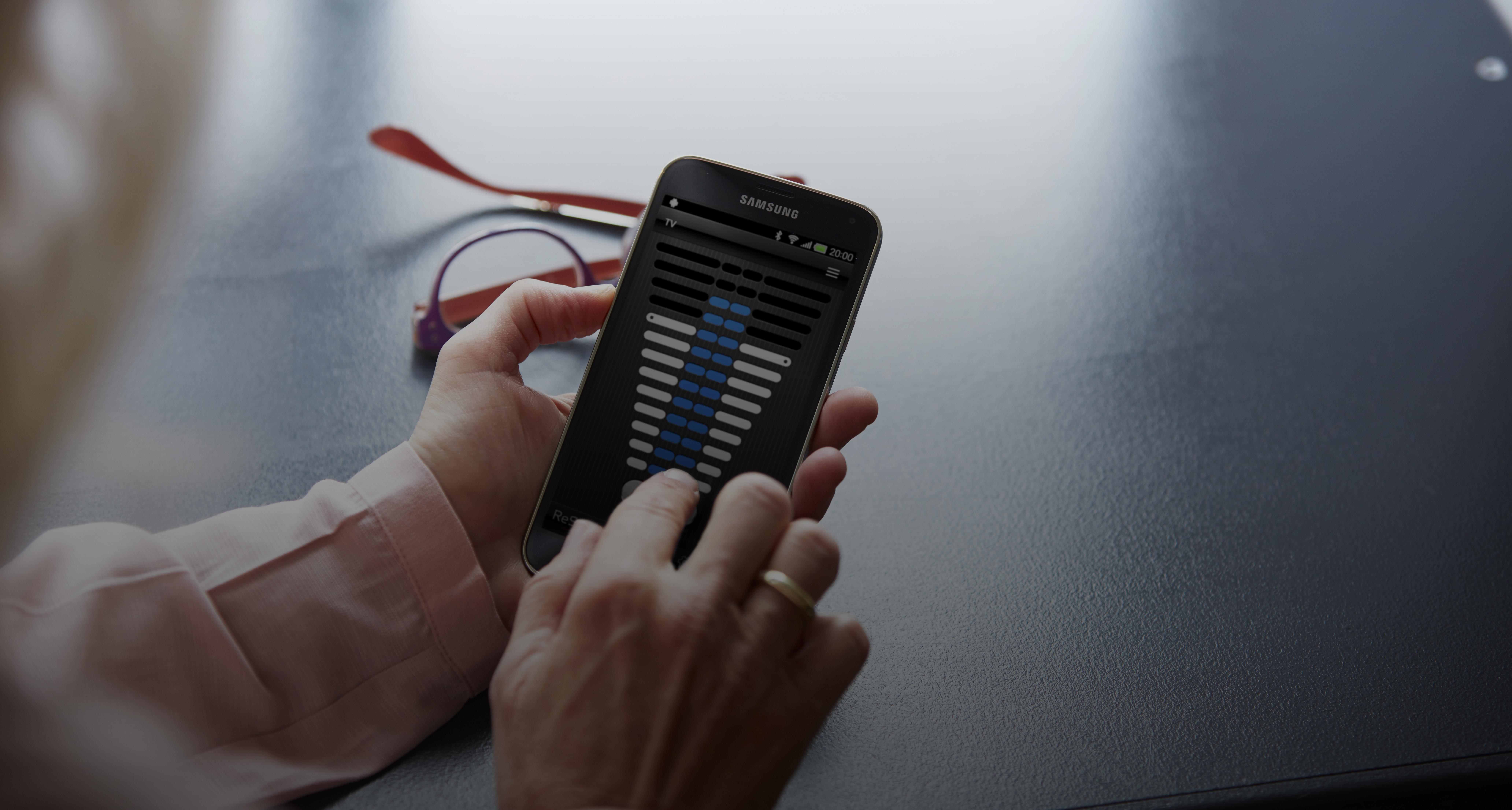 Control hearing aid app woman phone